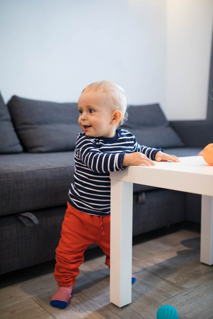 Baby's first steps are often with support from furniture