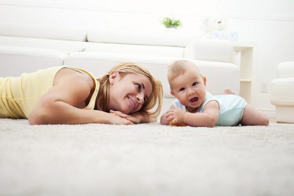 iStock_000027979590Large-mother-and-baby-playing-in-white-livingroom