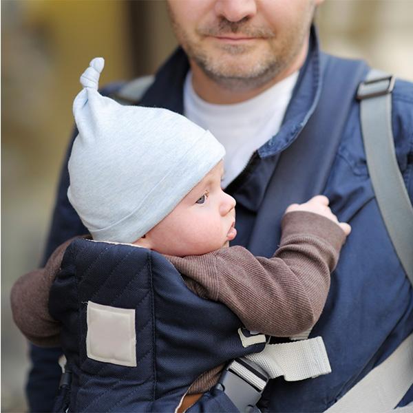 Father and his baby in a baby carrier